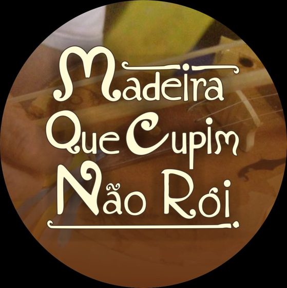 The Madeira Que Cupim Não Rói emblem — the project's name in cream lettering over hands playing a rabeca