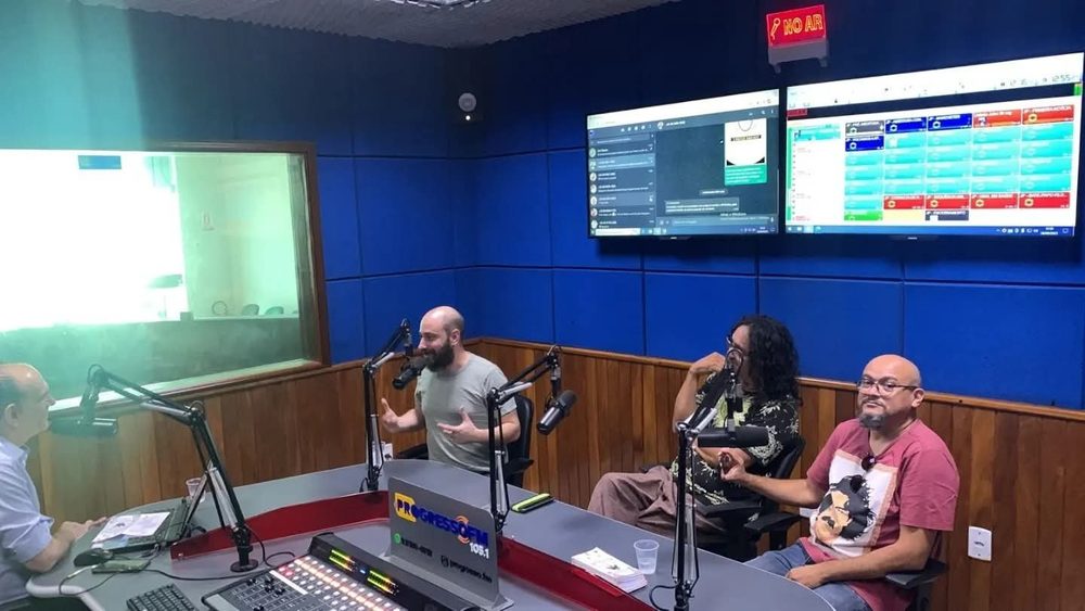 Three men at microphones in the Rádio Progresso FM studio, Juazeiro do Norte