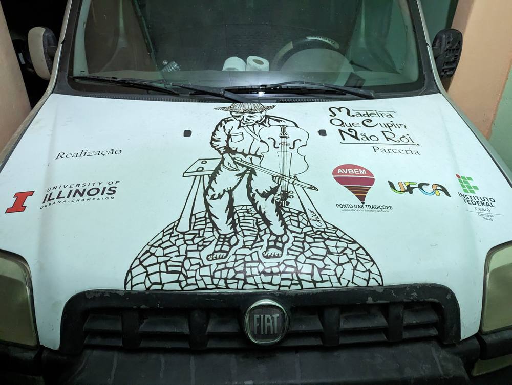 The Madeira Que Cupim Não Rói van, painted with a rabequeiro and the partners' logos